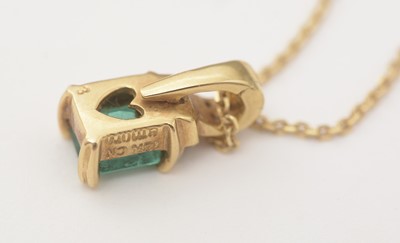Lot 166 - An emerald and diamond pendant on chain