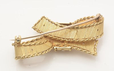 Lot 657 - An 18ct yellow gold and diamond bow pattern brooch