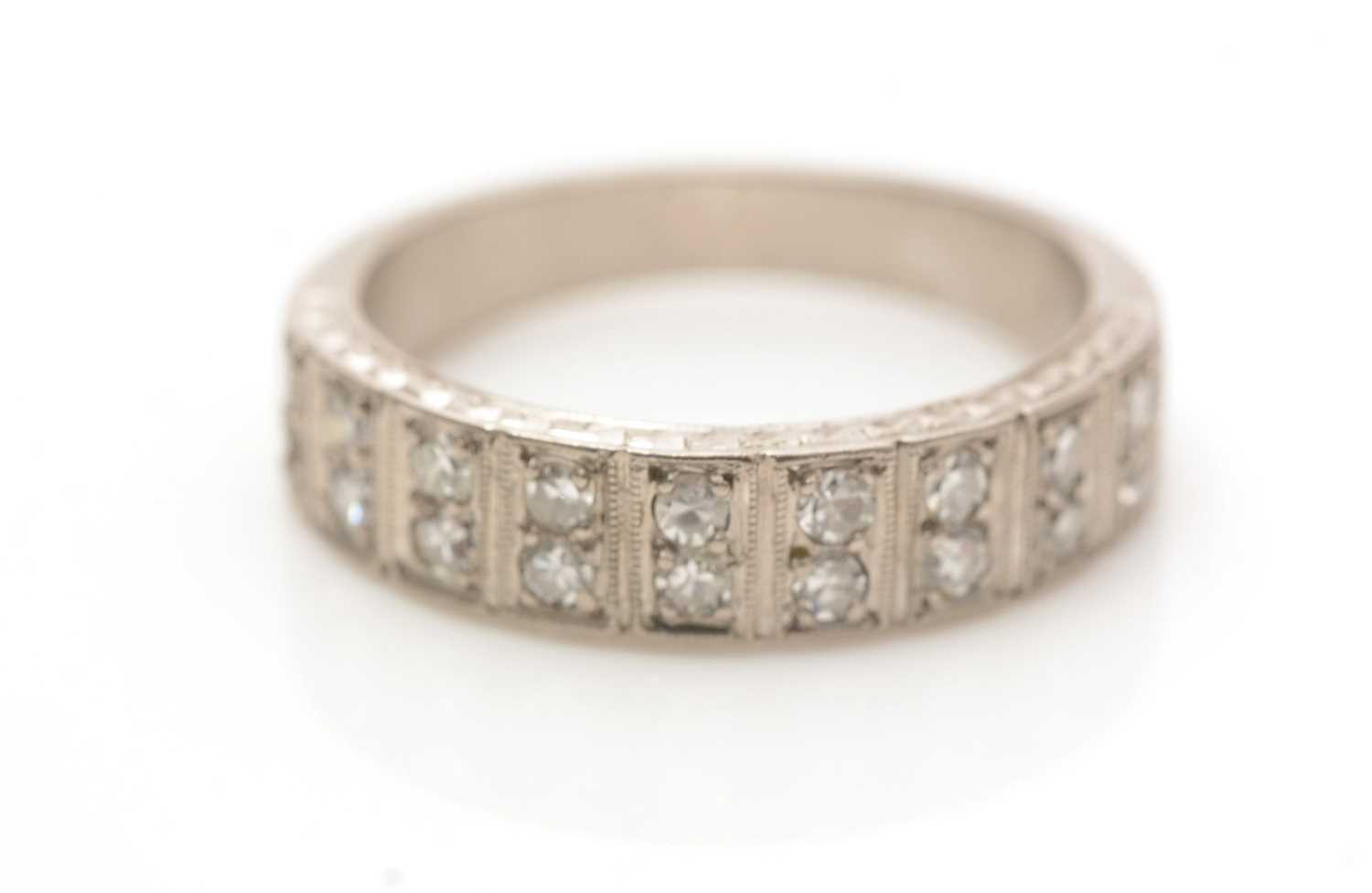 Lot 659 - A diamond half-hoop eternity ring