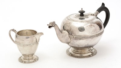 Lot 34 - A George V silver teapot and matching milk jug