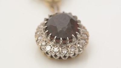 Lot 676 - A garnet and diamond cluster pendant necklace