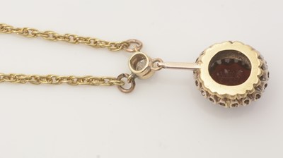 Lot 676 - A garnet and diamond cluster pendant necklace