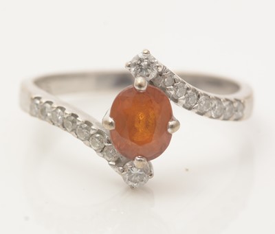 Lot 500 - An orange sapphire and diamond ring