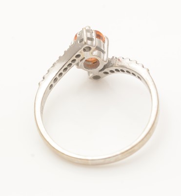 Lot 686 - An orange sapphire and diamond ring