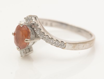 Lot 500 - An orange sapphire and diamond ring