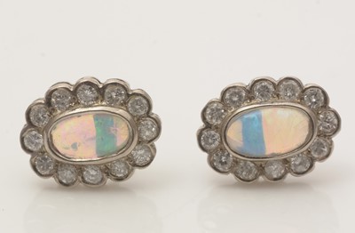 Lot 687 - A pair of opal and diamond cluster earrings