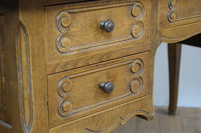 Lot 6 - A French-style oak serpentine fronted writing desk