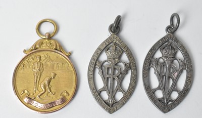 Lot 216 - A 9ct yellow gold bowling trophy medal fob; and two silver medals