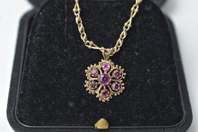 Lot 220 - A ruby and 9ct yellow gold pendant