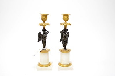 Lot 368 - A pair of French Neoclassical gilded bronze candlesticks