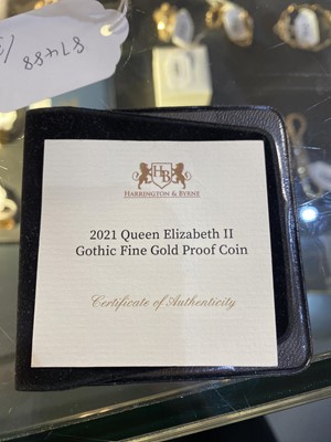 Lot 101 - A Queen Elizabeth II gold proof coin; and two one-eighth sovereigns
