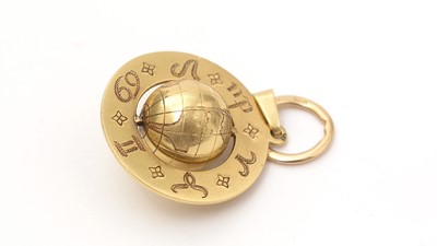 Lot 123 - An astrological yellow gold globe pendant