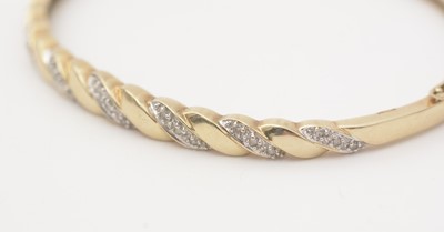 Lot 137 - A diamond and 9ct yellow gold bangle