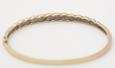 Lot 137 - A diamond and 9ct yellow gold bangle