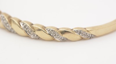 Lot 139 - A diamond and 9ct yellow gold bangle