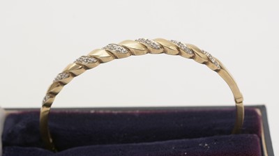 Lot 139 - A diamond and 9ct yellow gold bangle