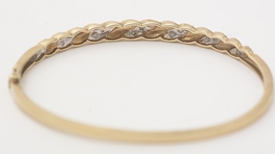 Lot 141 - A diamond and 9ct yellow gold bangle