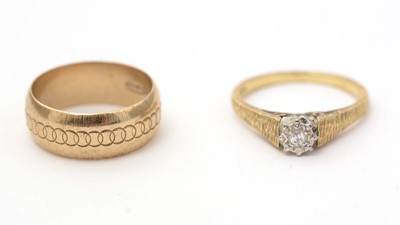 Lot 150 - A diamond single stone ring; and a gold band