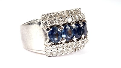 Lot 1184 - A sapphire and diamond half-hoop ring