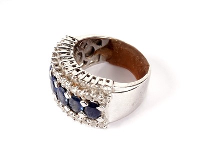 Lot 1184 - A sapphire and diamond half-hoop ring