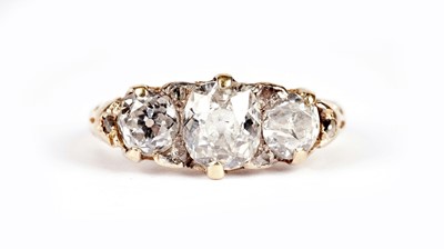 Lot 1129 - A Victorian three stone old-cut diamond ring