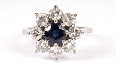 Lot 1130 - A sapphire and diamond cluster ring