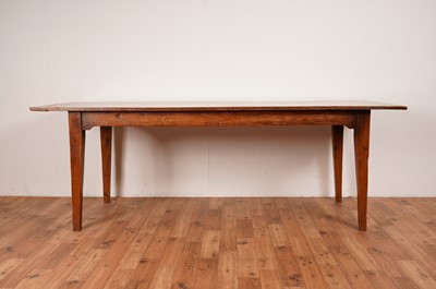 Lot 17 - A rustic French fruitwood refectory dining table
