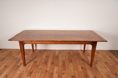 Lot 17 - A rustic French fruitwood refectory dining table