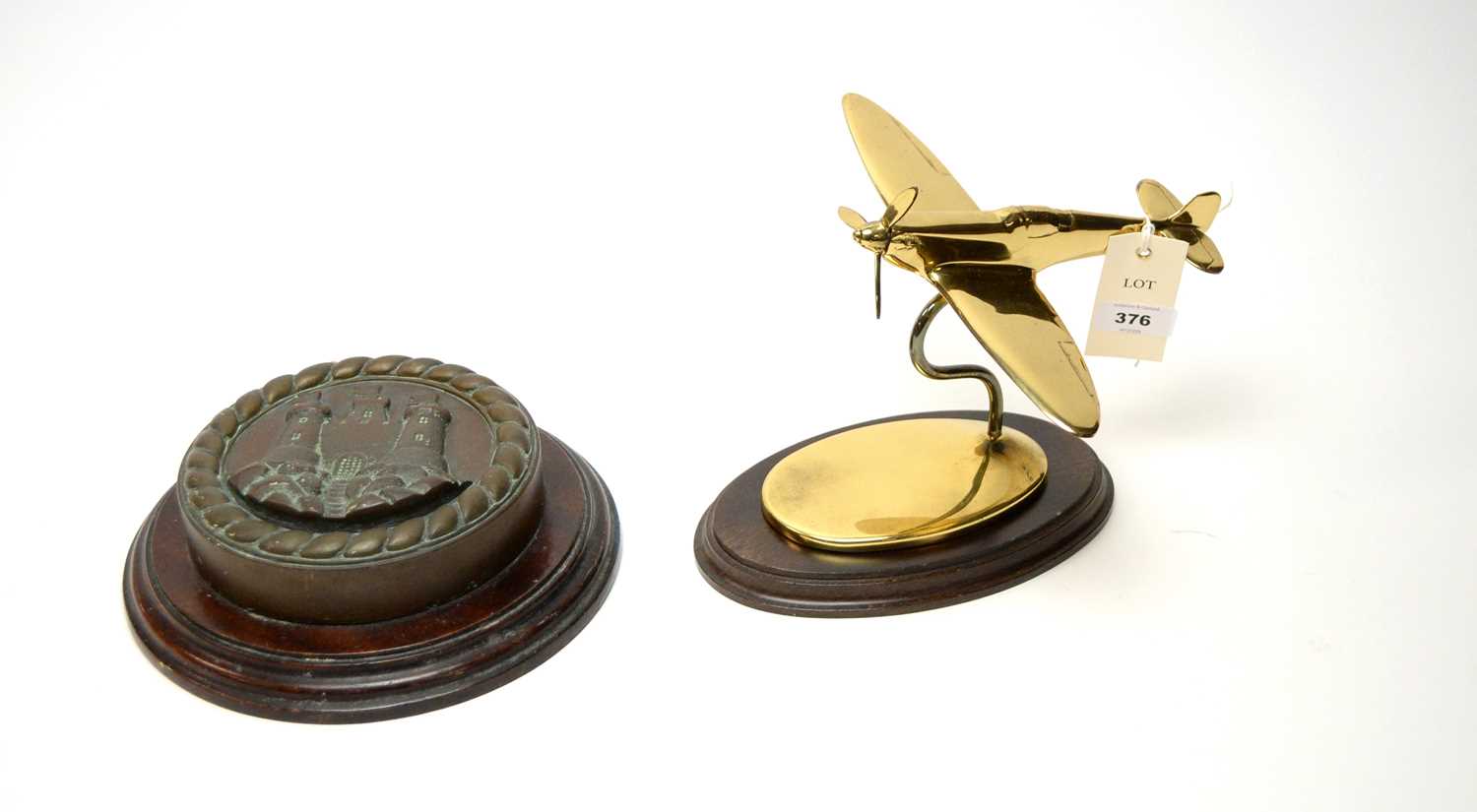 Lot 376 - A cast bronze ships tampion and a lacquered brass Spitfire