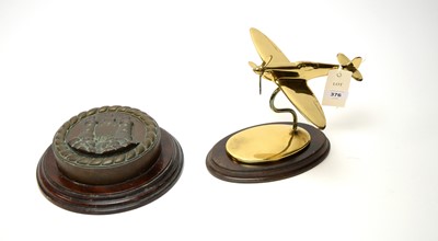 Lot 376 - A cast bronze ships tampion and a lacquered brass Spitfire