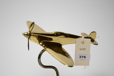 Lot 376 - A cast bronze ships tampion and a lacquered brass Spitfire