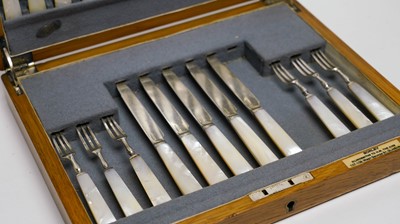 Lot 110 - An early 20th Century walnut canteen of cutlery