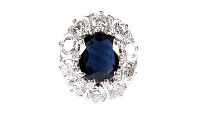 Lot 1199 - A sapphire and diamond cluster ring
