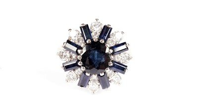 Lot 1200 - A sapphire and diamond cluster ring