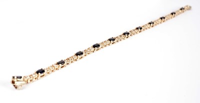 Lot 1201 - A sapphire and diamond line bracelet