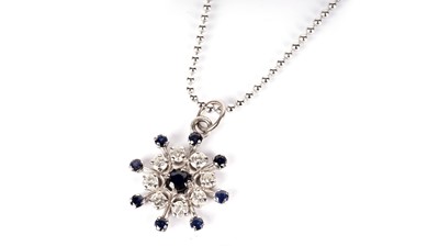 Lot 1203 - A sapphire and diamond snow-flake pattern pendant