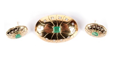 Lot 1205 - An emerald and diamond brooch and matching earrings