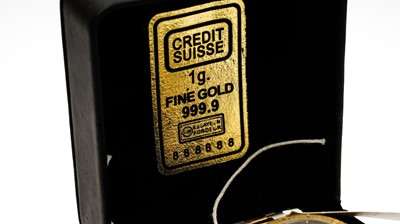 Lot 430 - A Credit Suisse 1g gold ingot inset into the dial of a gilt steel wristwatch