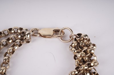 Lot 490 - A yellow gold muff chain and triple strand bracelet