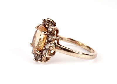 Lot 433 - A topaz and diamond ring; and a cluster ring