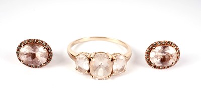 Lot 440 - A pink three-stone dress ring; and a pair of earrings