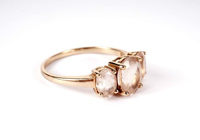 Lot 440 - A pink three-stone dress ring; and a pair of earrings