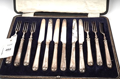 Lot 402 - A set of silver handled knives and forks and other cutlery