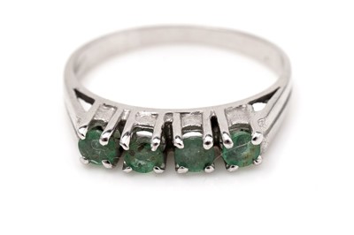 Lot 464 - A four stone emerald ring