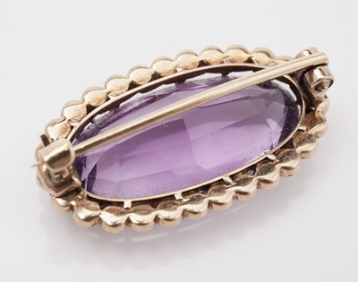 Lot 450 - An Edwardian amethyst and seed pearl brooch