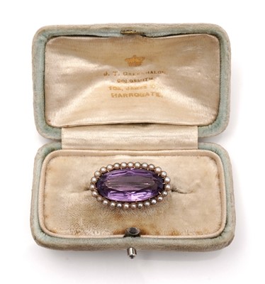 Lot 450 - An Edwardian amethyst and seed pearl brooch