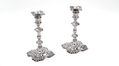 Lot 380 - A pair of late George II cast candlesticks