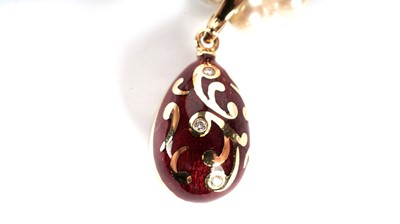 Lot 1217 - Faberge: an egg-pattern pendant on cultured pearl necklace