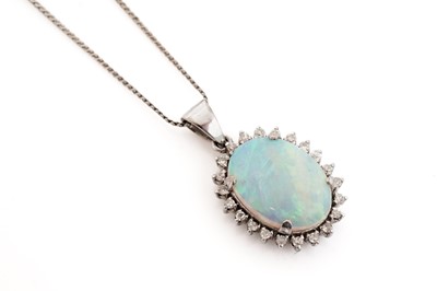Lot 563 - An opal and diamond pendant on chain