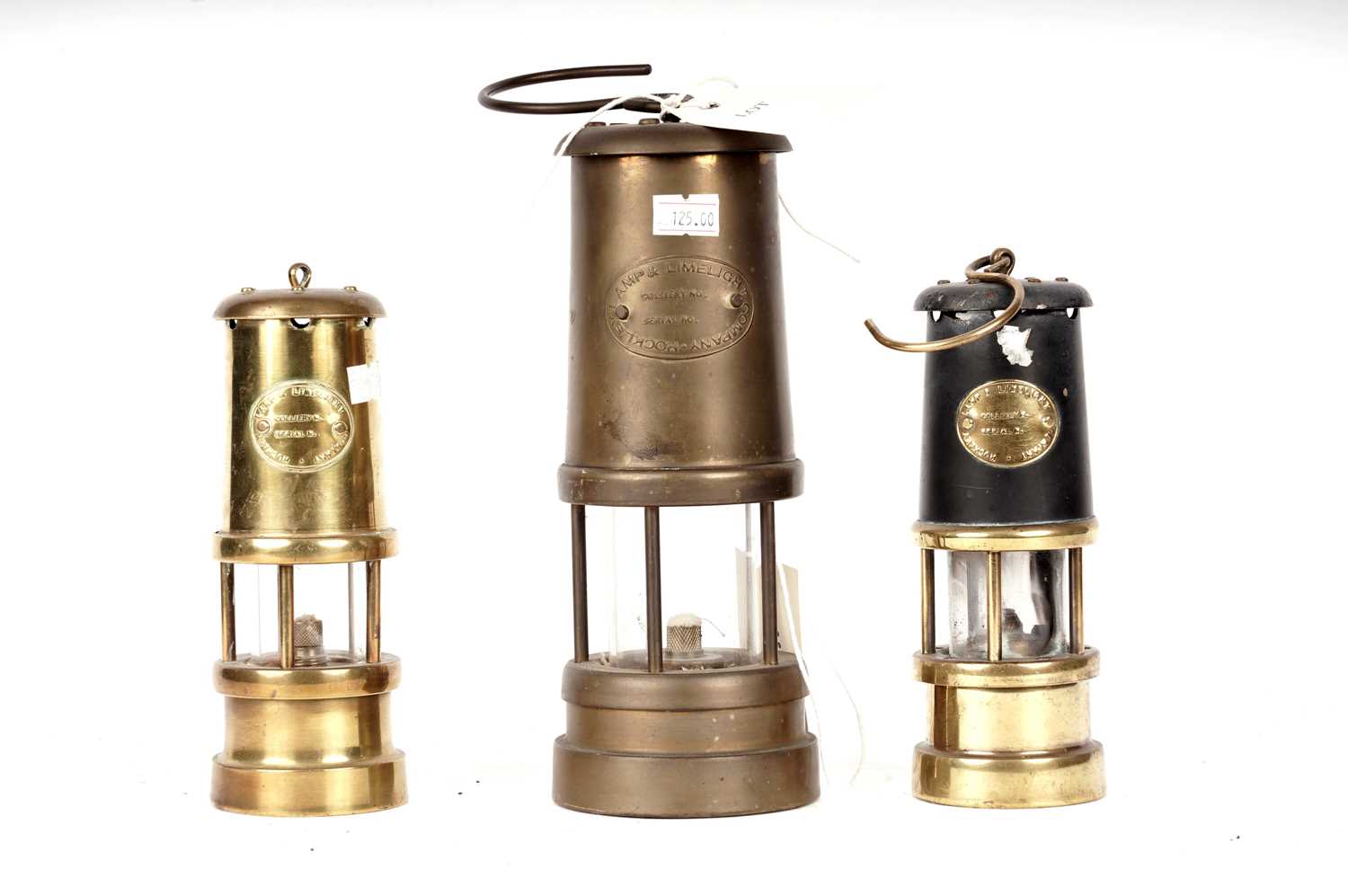 Lot 87 - Three brass miners safety lamps